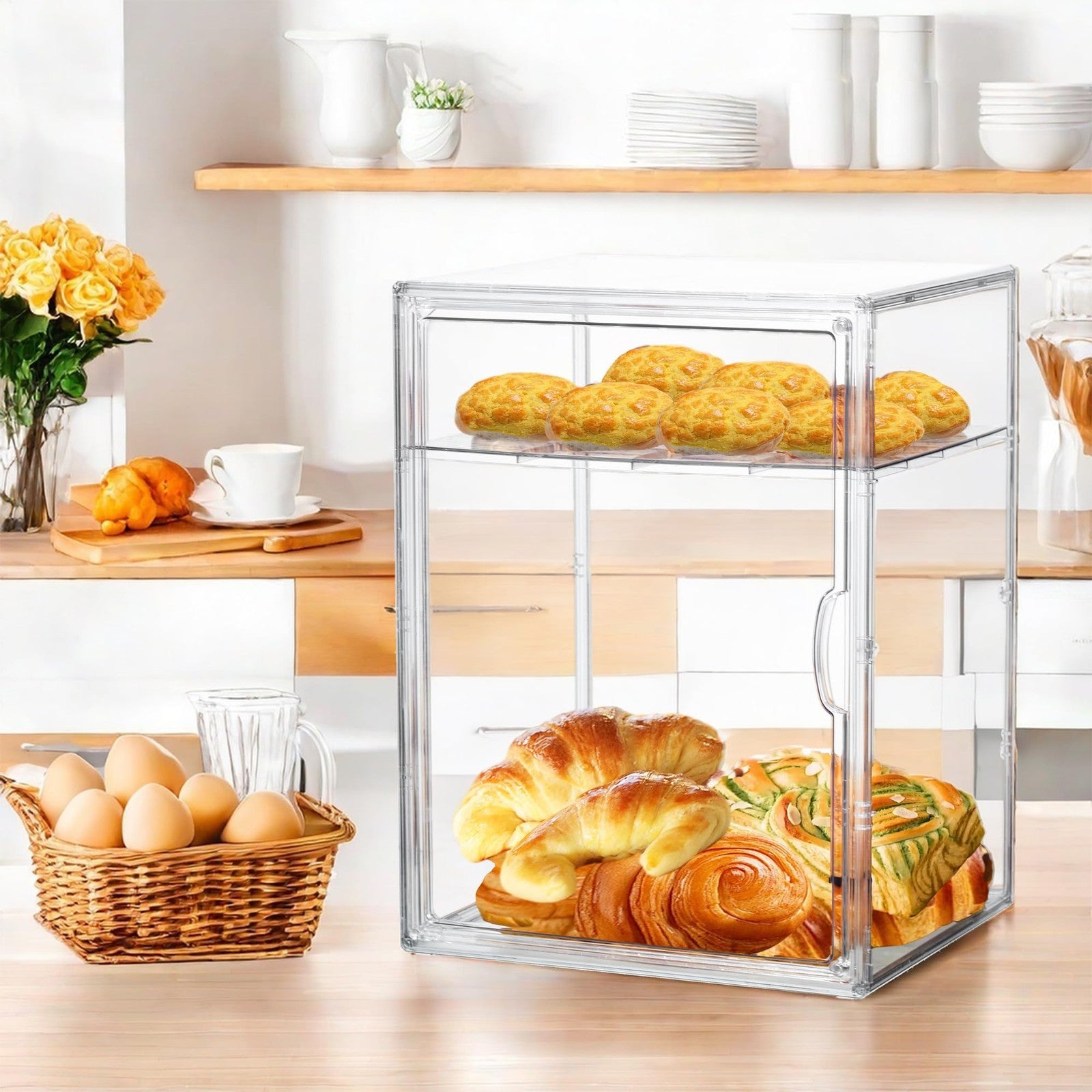 Attelite pastry display case with four adjustable clear layers for bread and baked goods in a kitchen or bakery setting.
