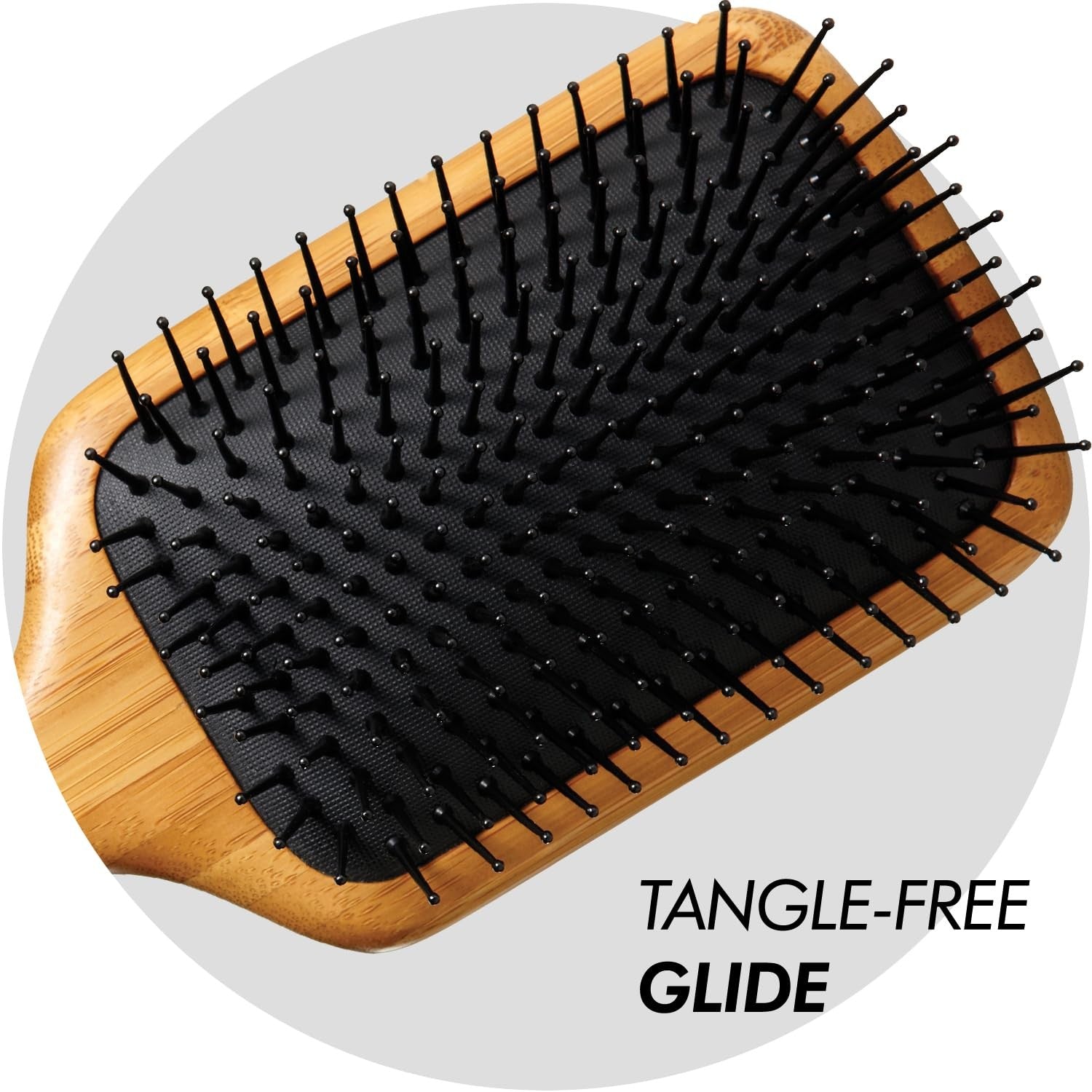 Sam Villa Signature Series bamboo paddle hair brush with wooden handle for styling and detangling hair.