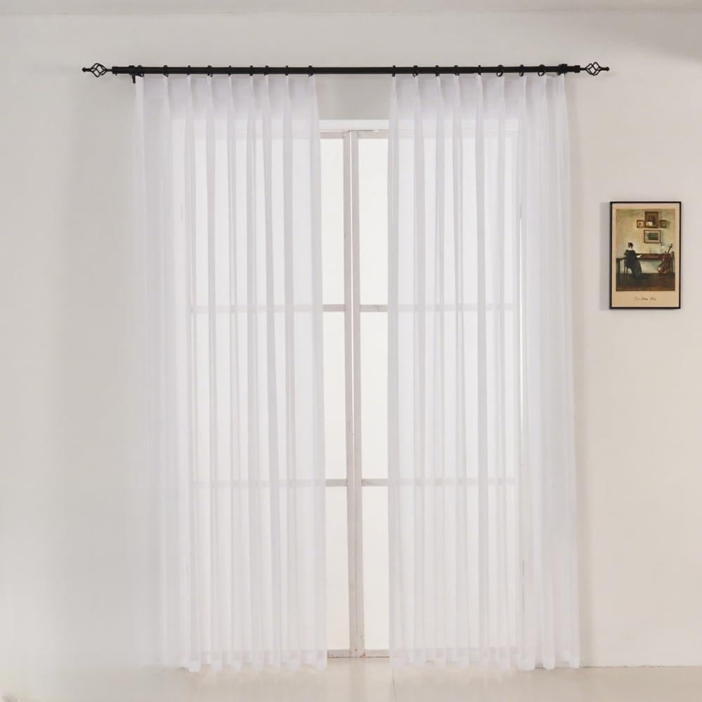 LUGOTAL Pure White 90-inch pinch pleated chiffon sheer curtains hanging in a window, showcasing elegant, lightweight fabric.