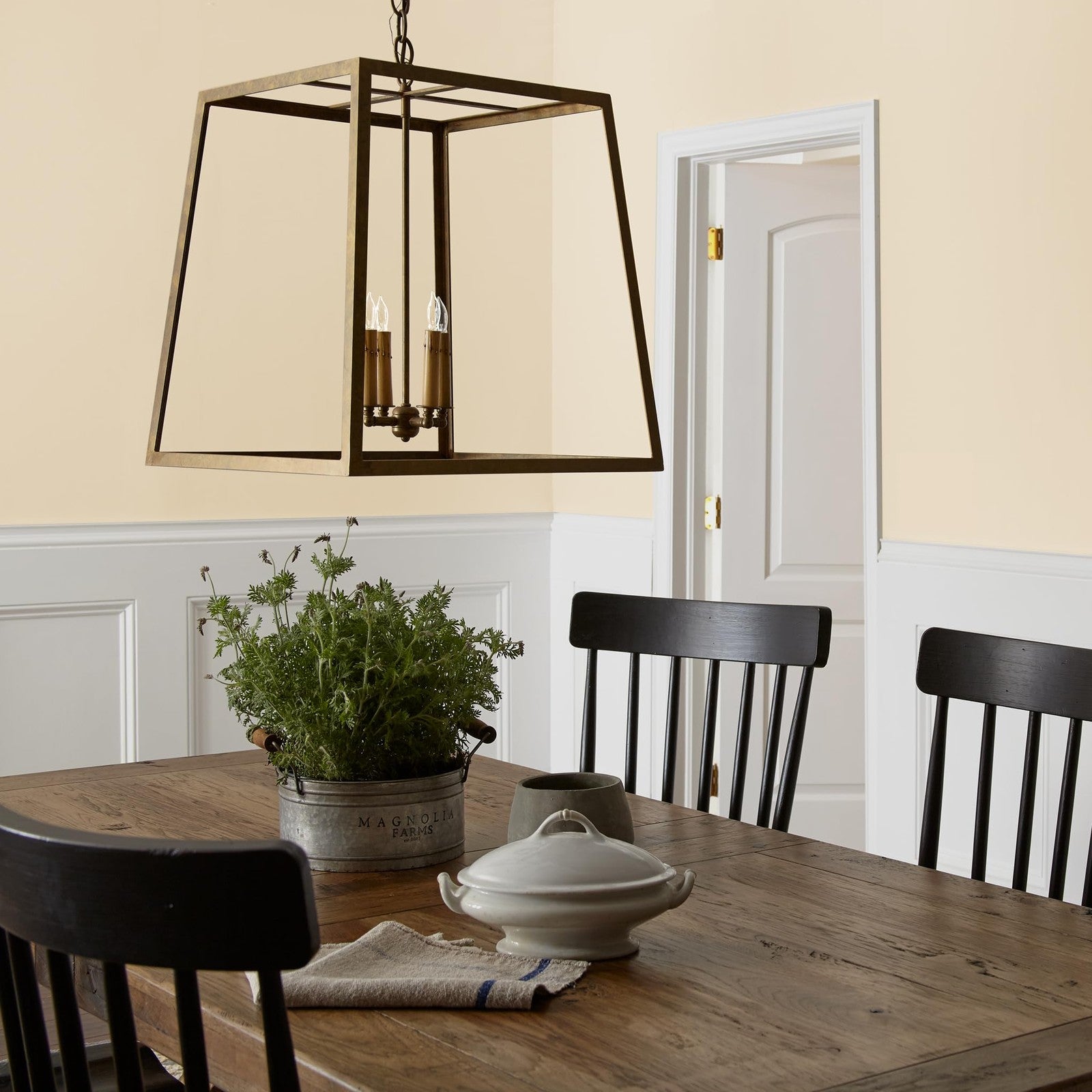 KILZ Magnolia Home Joanna Gaines classic interior wall and ceiling trim paint and primer in a neutral color, applied on wall and ceiling edges.