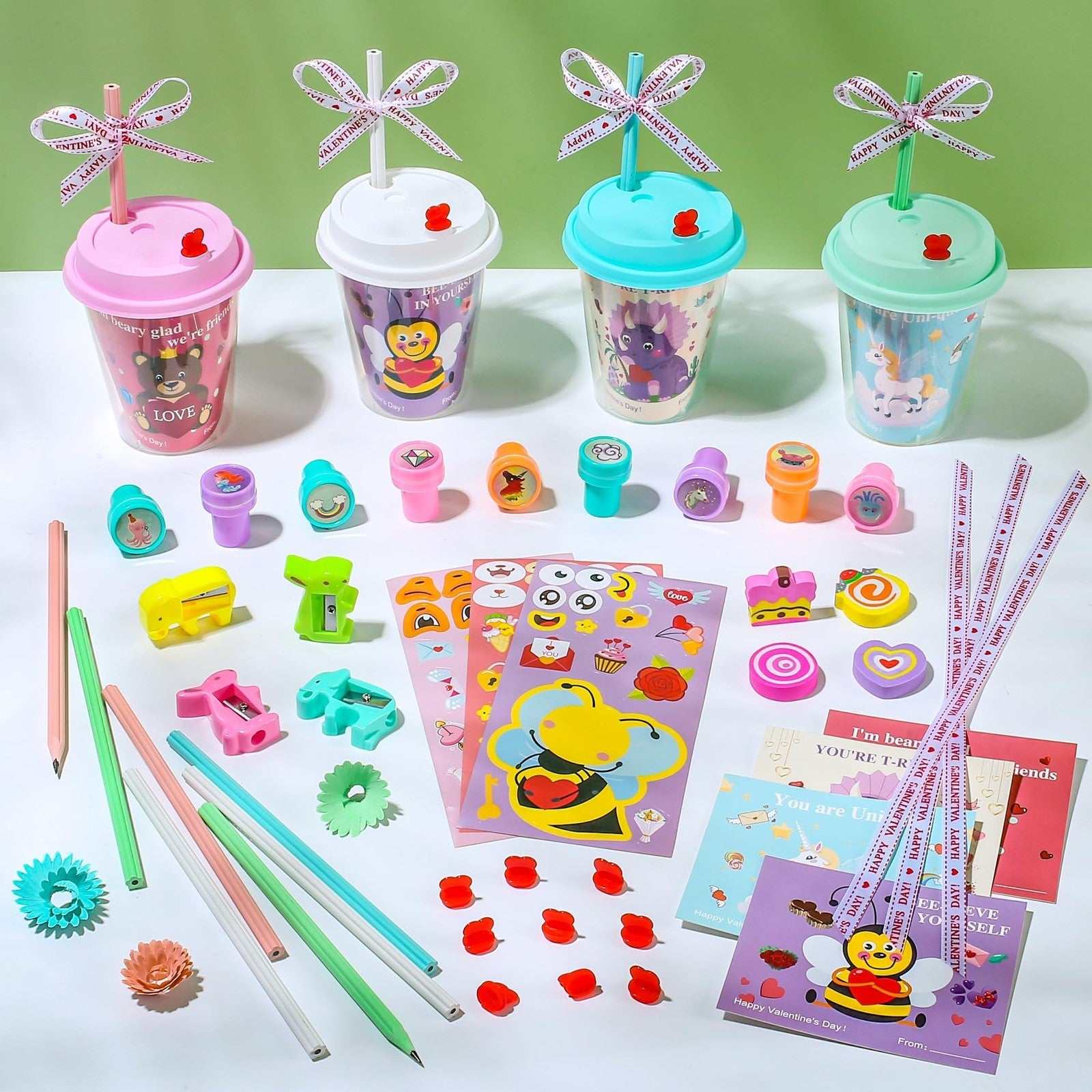 24-pc Valentine’s Day stationery set with mugs, cards, stickers, erasers, pencils, sharpeners, stamps, and ribbons in pastel colors for kids classroom exchange