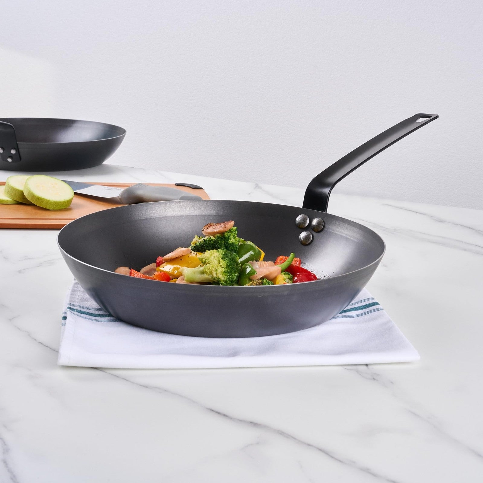 Restaurantware Met Lux 12-inch lightweight fry pan with triple-rive induction-ready cooking surface, shown with a black handle.