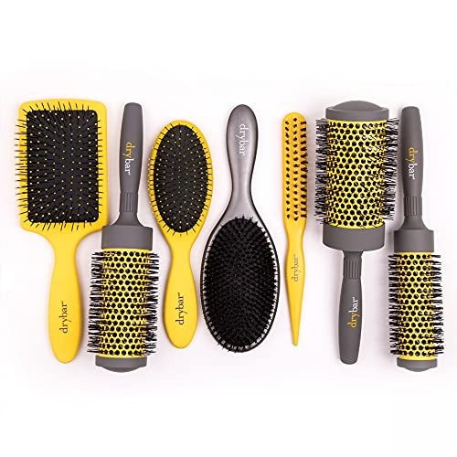 Drybar The Lemon Bar paddle brush with yellow handle and wide bristles for detangling and styling hair.