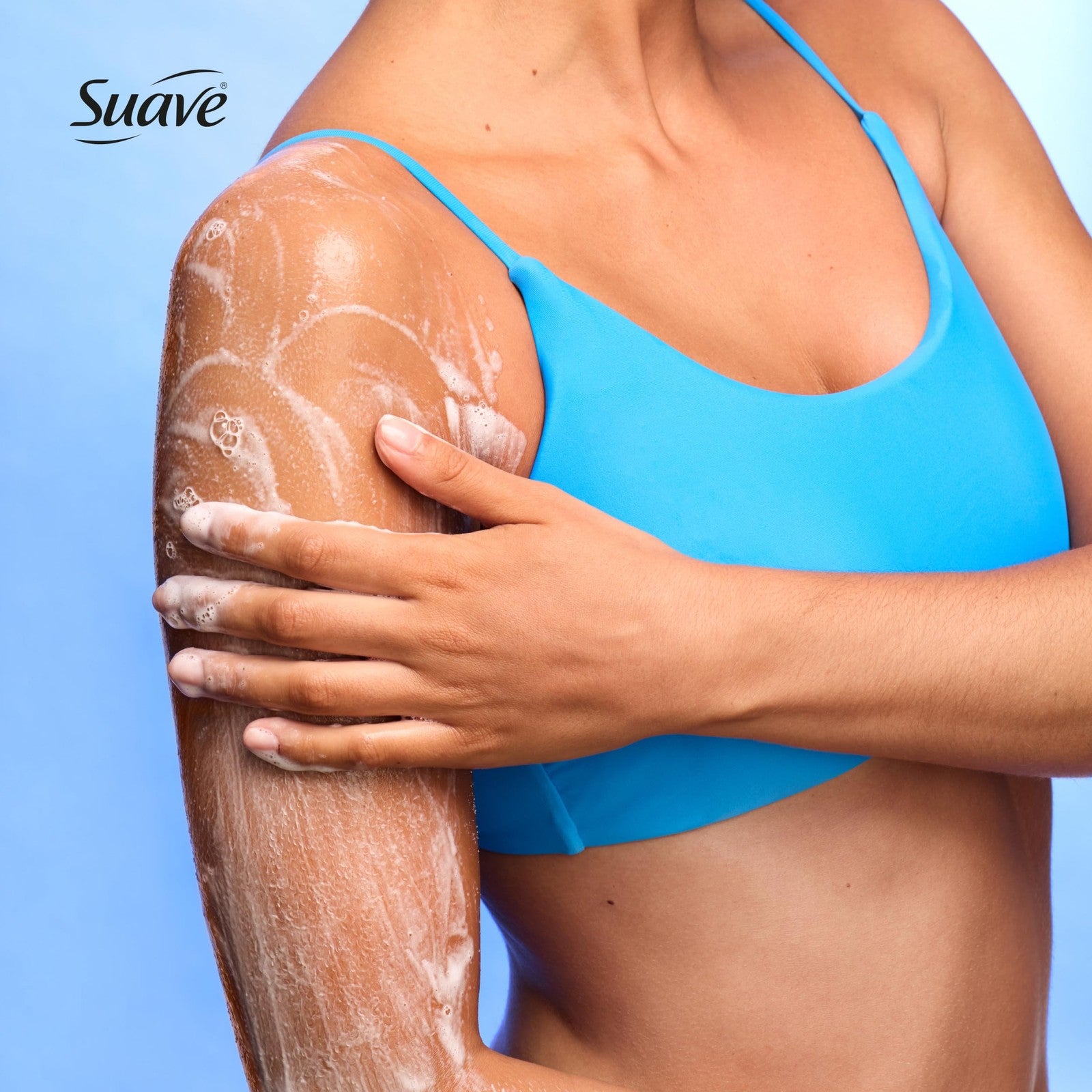 Suave Citrus Blossom exfoliating body wash and scrub with glycerin and vitamin E, shown in a clear bottle with citrus slices.