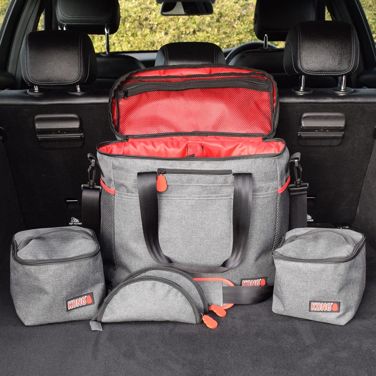 KONG 5-piece pet travel bag set with washable tote, food storage containers, and collapsible bowls for pet travel convenience.