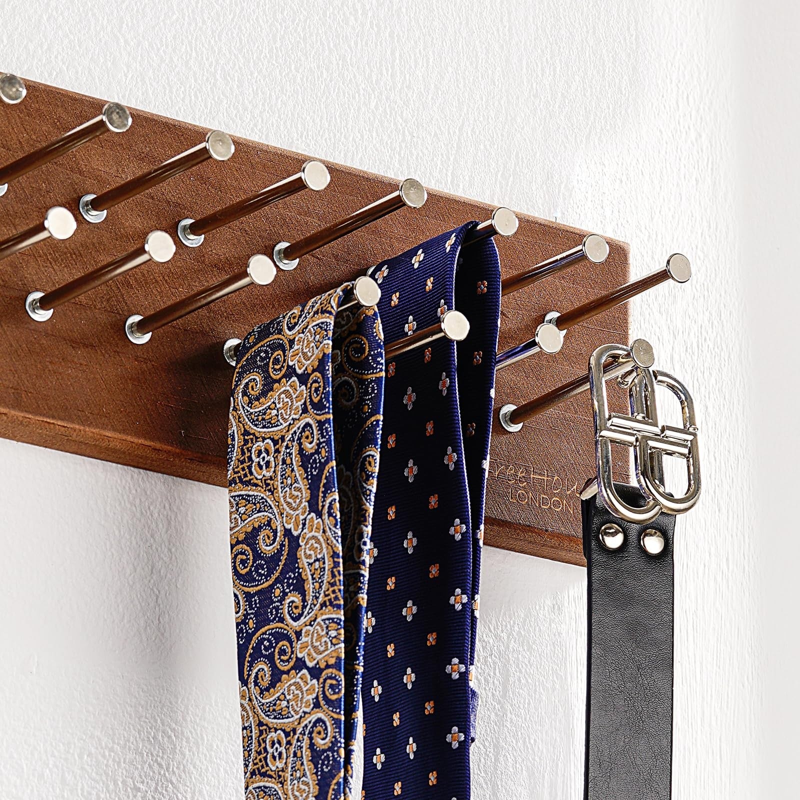 Treehouse London tie rack organizer holds 40 large ties, made of solid wood with sturdy metal construction, shown hanging on a wall.