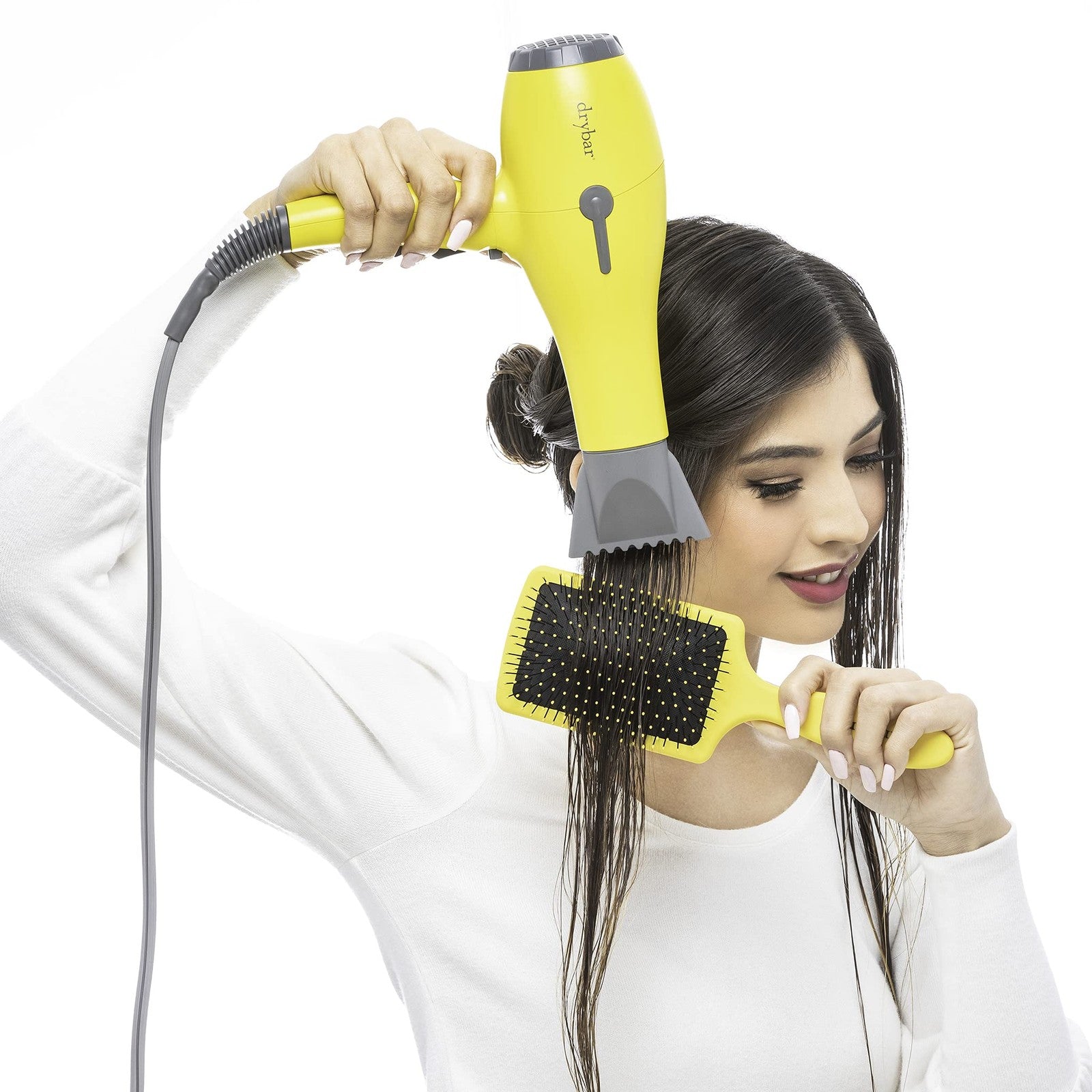 Drybar The Lemon Bar paddle brush with lemon yellow handle and wide-bristle design for detangling and styling hair.