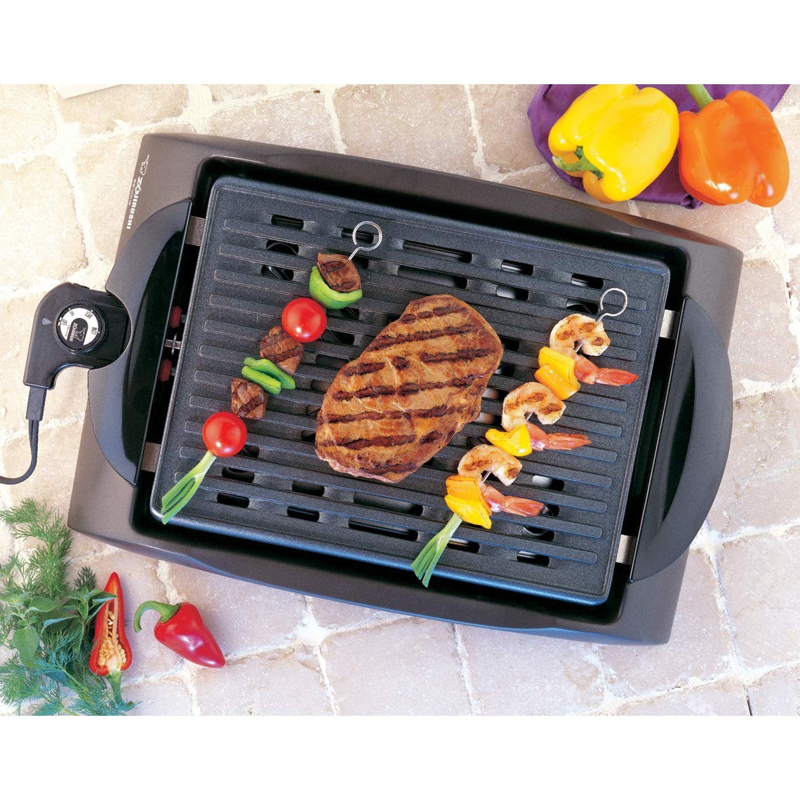 Zojirushi EB-CC15 indoor electric grill with non-stick surface and adjustable temperature control on a kitchen countertop.