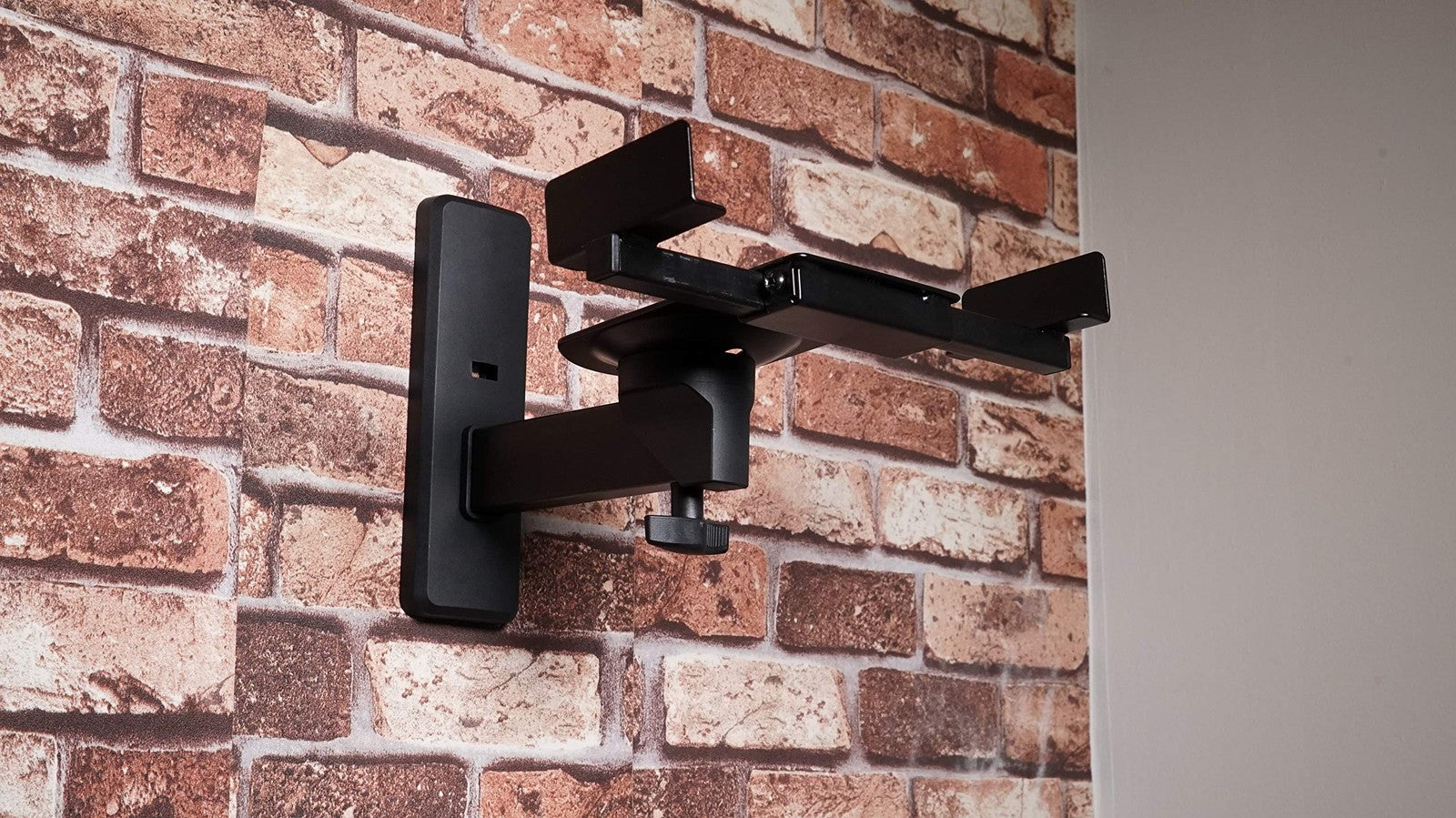 Pair of Rockville RHSB8 adjustable wall mount speaker brackets with 180-degree swivel, shown installed for versatile speaker placement.