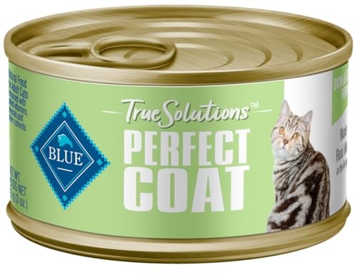 Canned Blue Buffalo True Solutions Skin & Coat adult wet cat food with whitefish in a metal bowl, showcasing the product's packaging and food.