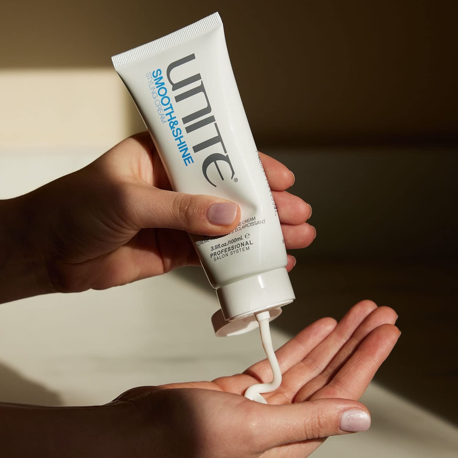 UNITE Hair SMOOTH&SHINE Styling Cream jar with cream inside, designed to tame frizz and add shine and softness to hair.
