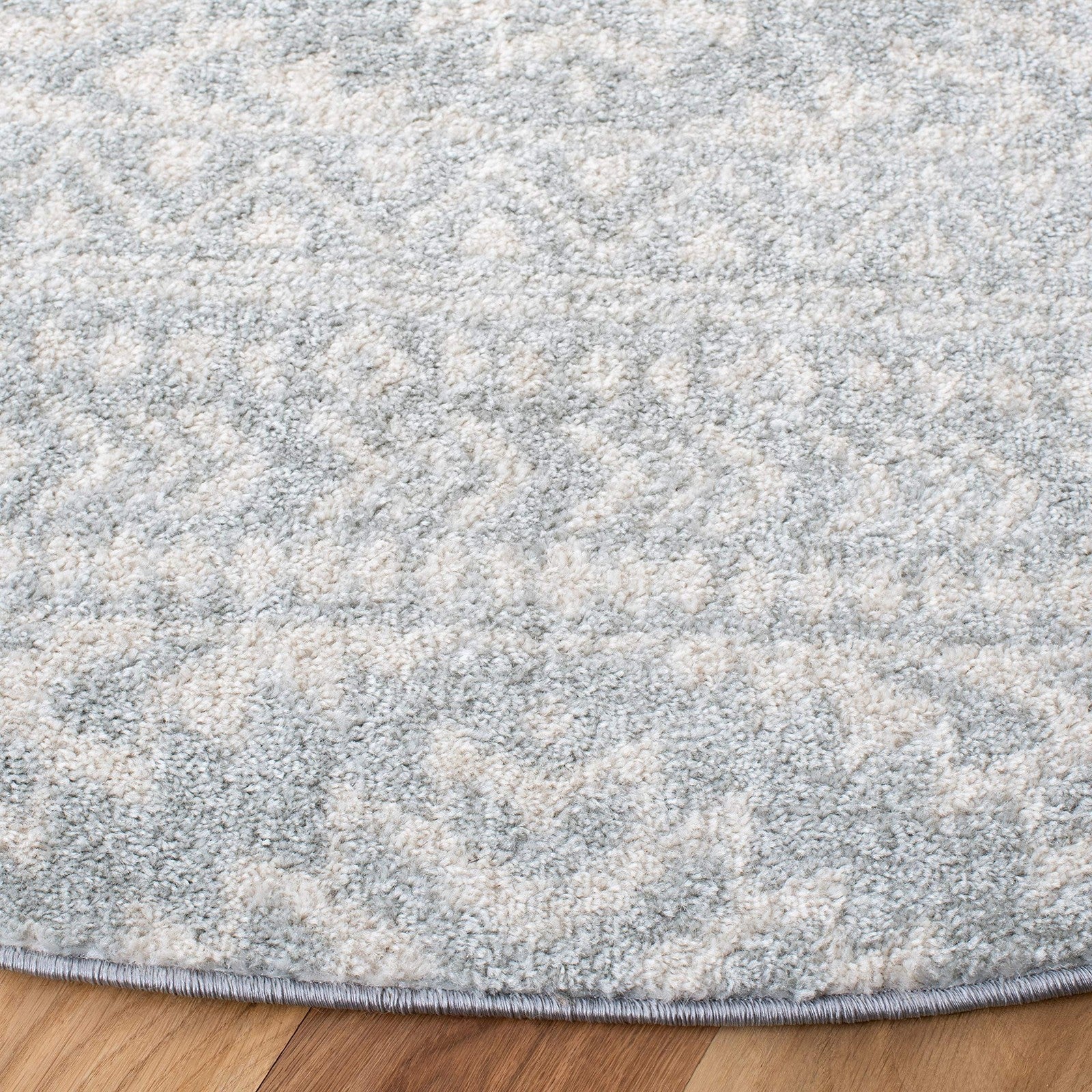 Round Safavieh Tulum Collection area rug with light grey and ivory Moroccan boho design, perfect for modern living spaces.