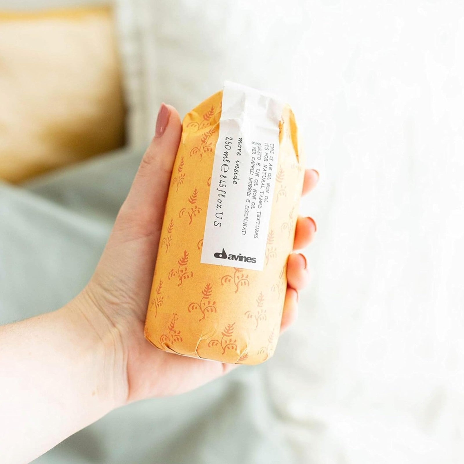 Davines This is an Oil Non Oil with hydrating texture and smooth finish, shown in a sleek bottle, for a natural, hydrated look.