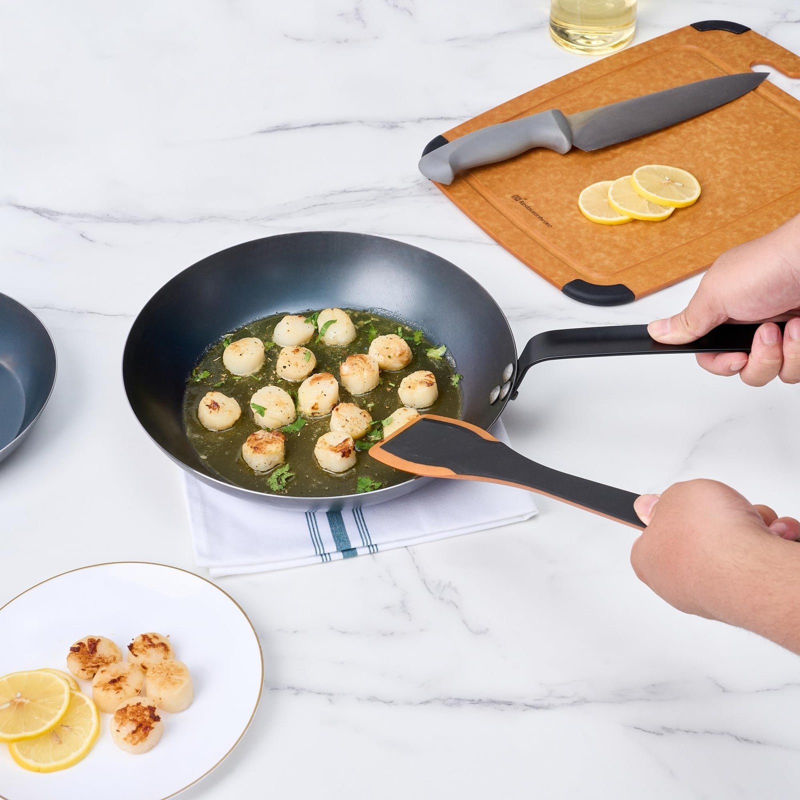 Restaurantware Met Lux 11-inch lightweight frying pan with triple-rive induction-ready surface, shown with a cooked dish inside.
