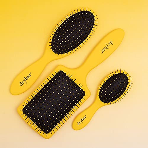 Drybar The Lemon Bar Paddle Brush with wide teeth for smooth, gentle detangling and styling of hair.