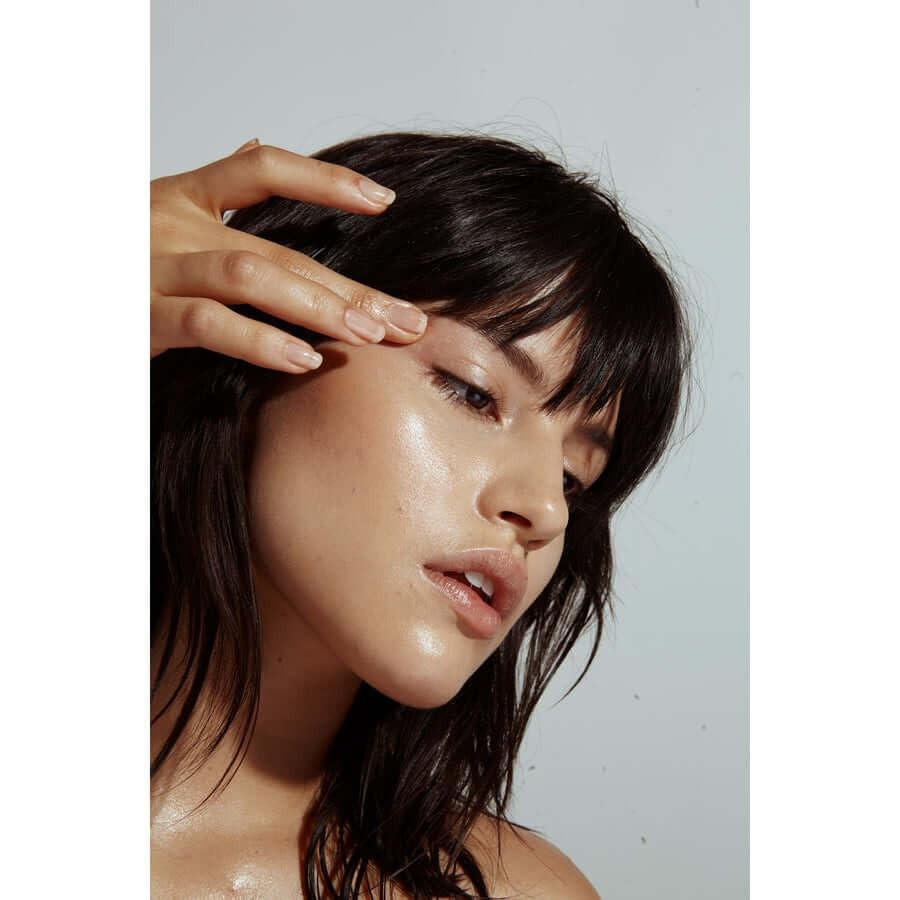 NOTO Botanics Organic Hydra Highlighter Stick for face and body, natural non-toxic skincare product with a sleek silver packaging