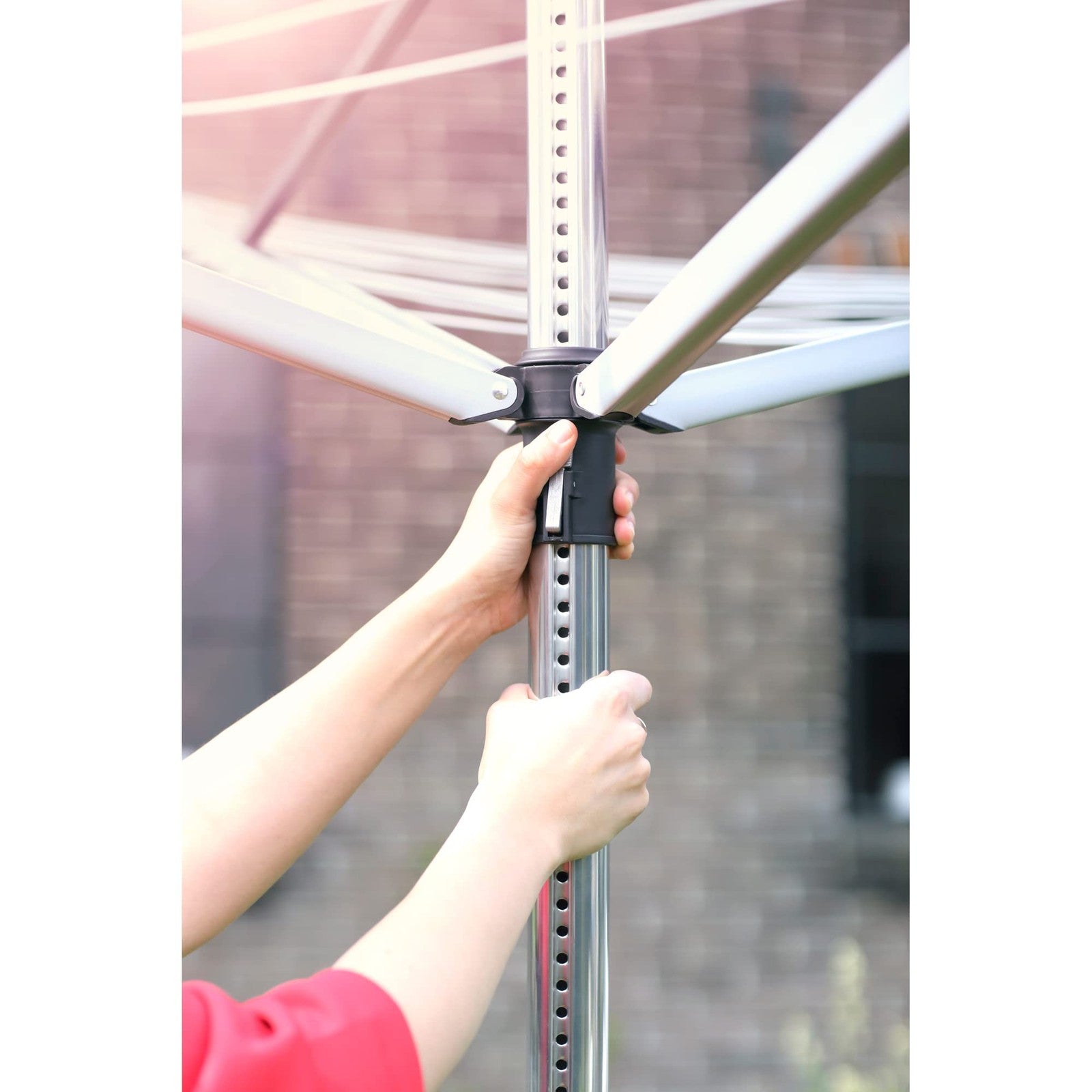 Brabantia Lift-O-Matic outdoor clothesline with four arms, 197ft length, adjustable height, and foldable design for easy drying.