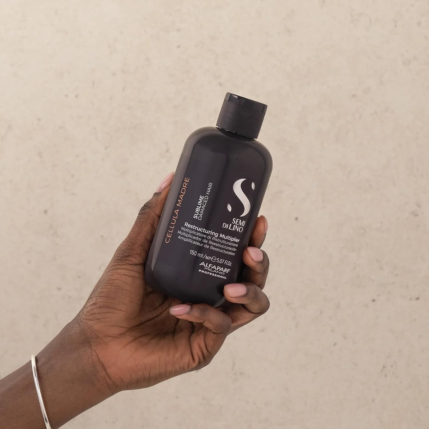 ALFAPARF MILANO Semi di Lino Sublime Cellula Madre Restructuring Multiplier Hair treatment in a sleek bottle with a pump dispenser.