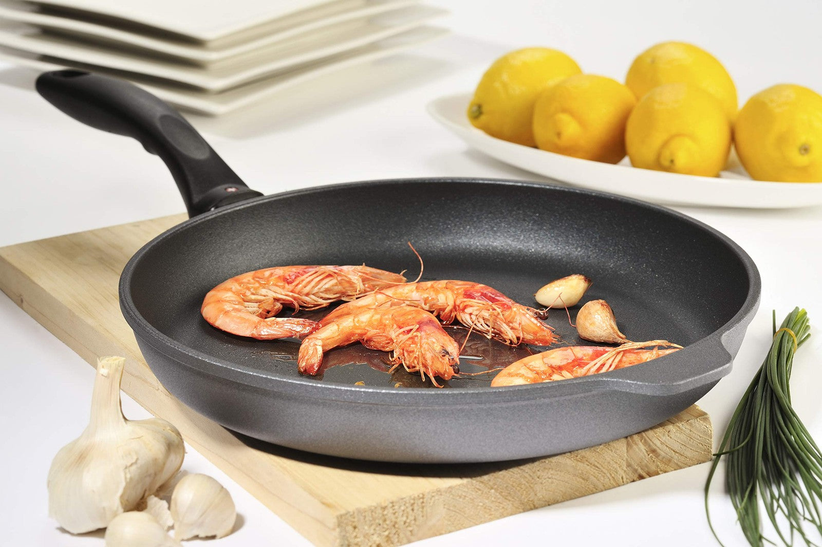 Swiss Diamond nonstick frying pan with lid, featuring durable diamond-coated nonstick surface and ergonomic handle.