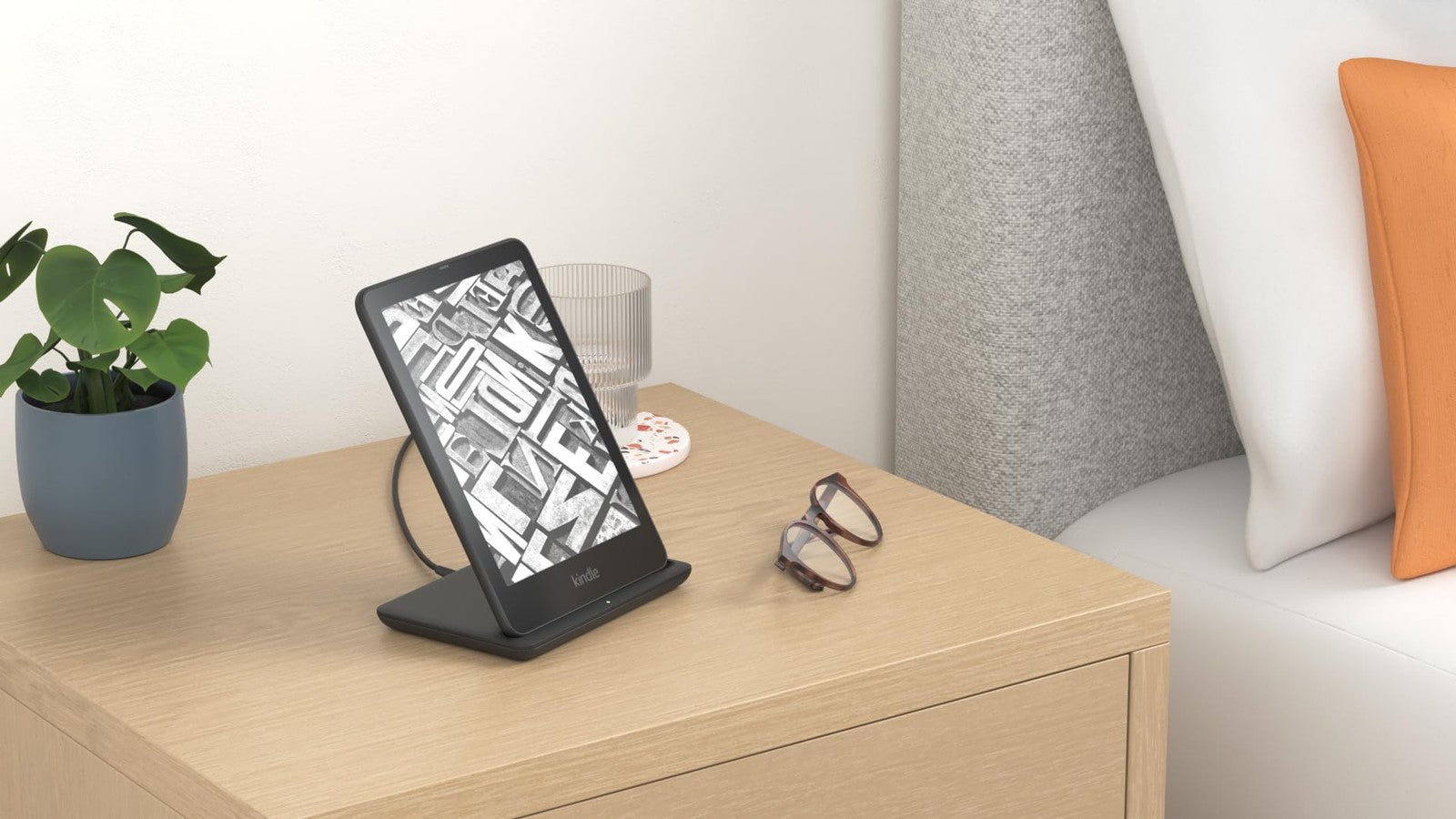 Anker wireless charging dock for Kindle Paperwhite and Colorsoft Signature Edition, white charging station on desk.