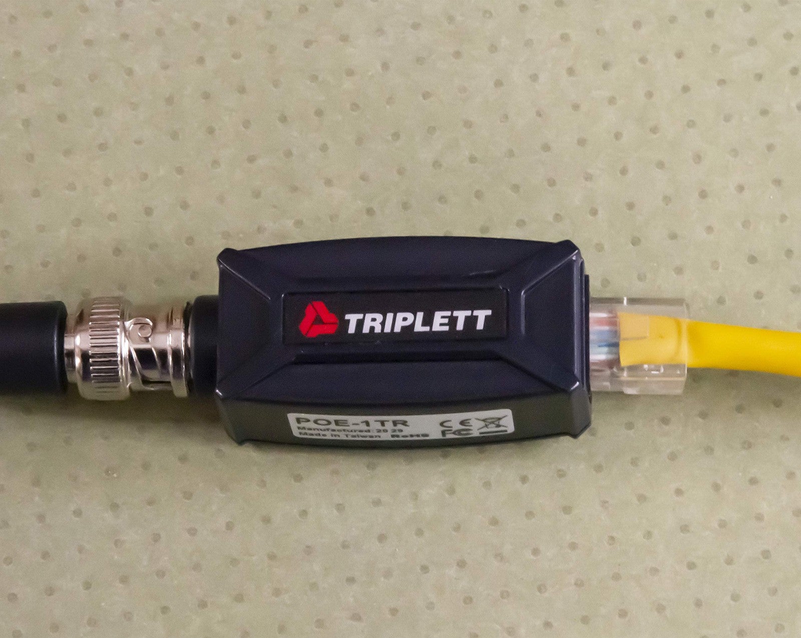 Triplett GEM IP camera signal extender over coax cable showing device connected to coax for long-distance data transmission up to 984 feet.