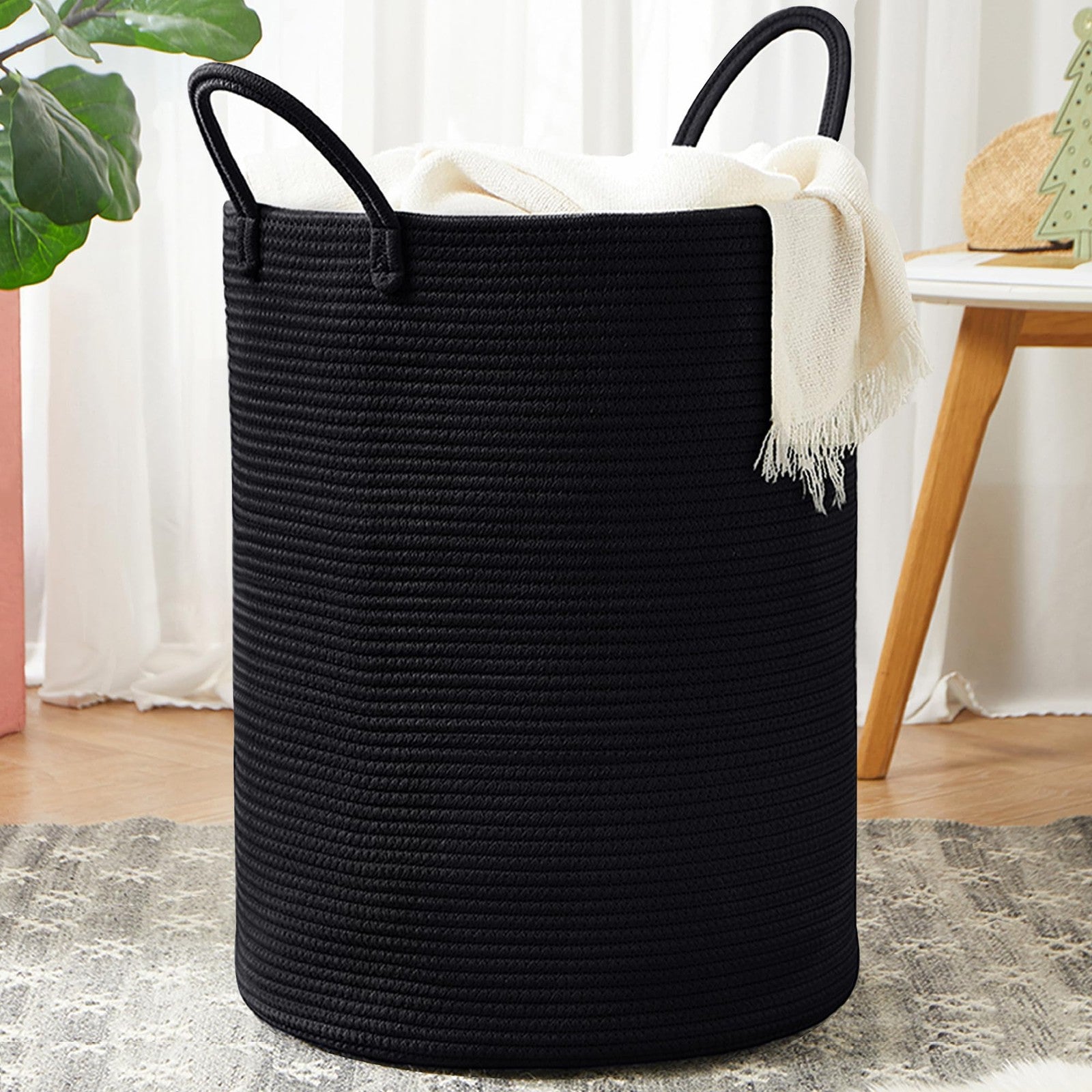 Black woven rope laundry hamper by MOJOSCEND, tall modern design with open top for clothes storage.