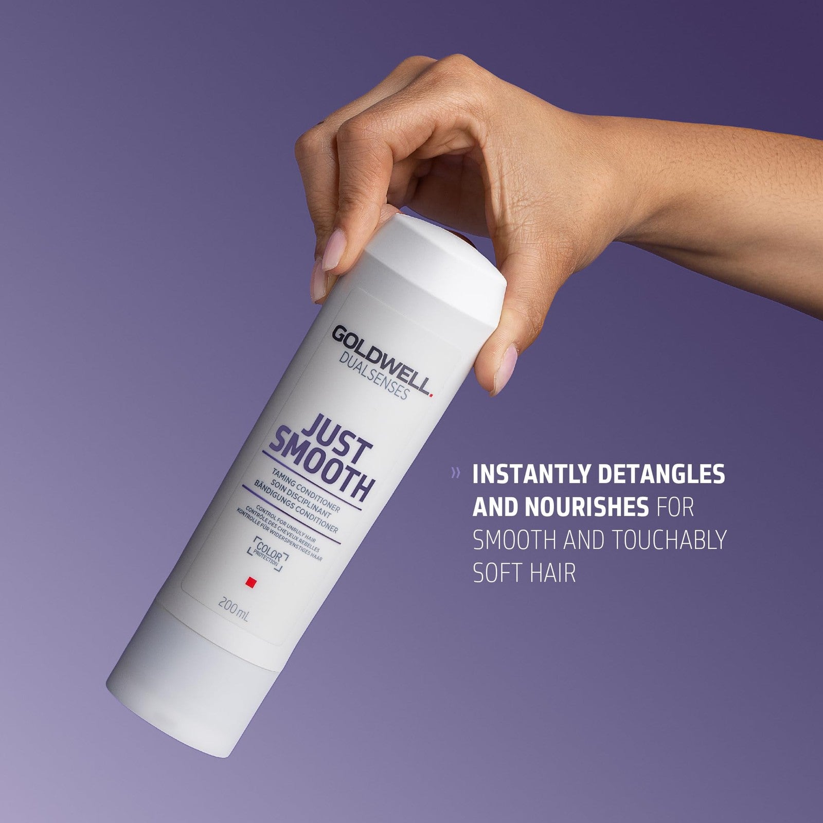 Goldwell Dualsenses Just Smooth anti-frizz conditioner bottle with gold and black packaging, designed to control humidity and tame frizz