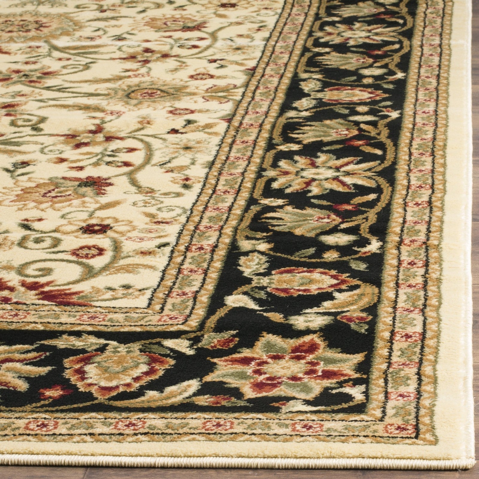 Safavieh Lyndhurst ivory and black traditional area rug featuring intricate patterns and a plush, textured surface.