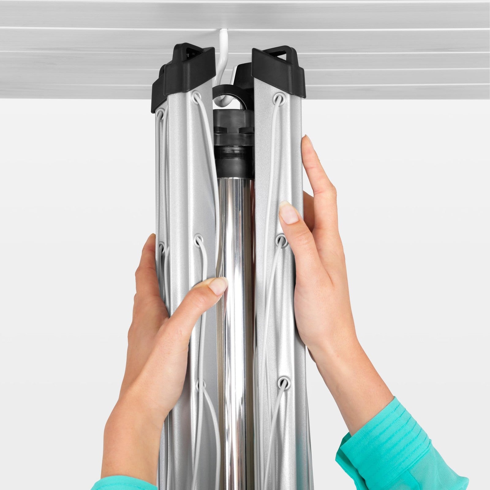 Brabantia Topspinner 4-arm outdoor clothesline with 197ft drying space, shown rotating and folded for easy outdoor laundry drying.