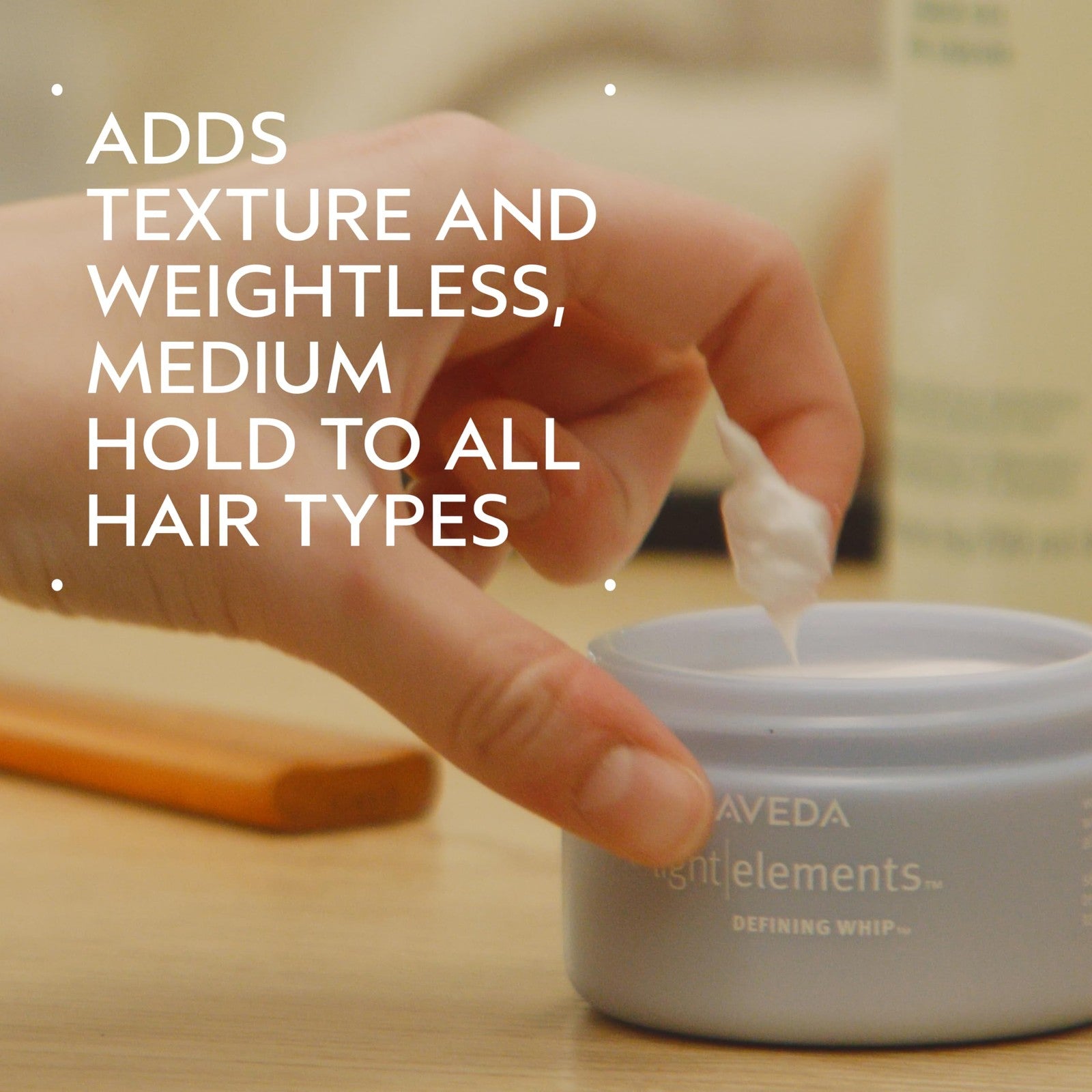 Aveda Light Elements Defining Whip styling wax for hair, showing the lightweight texture and creamy consistency in a jar.