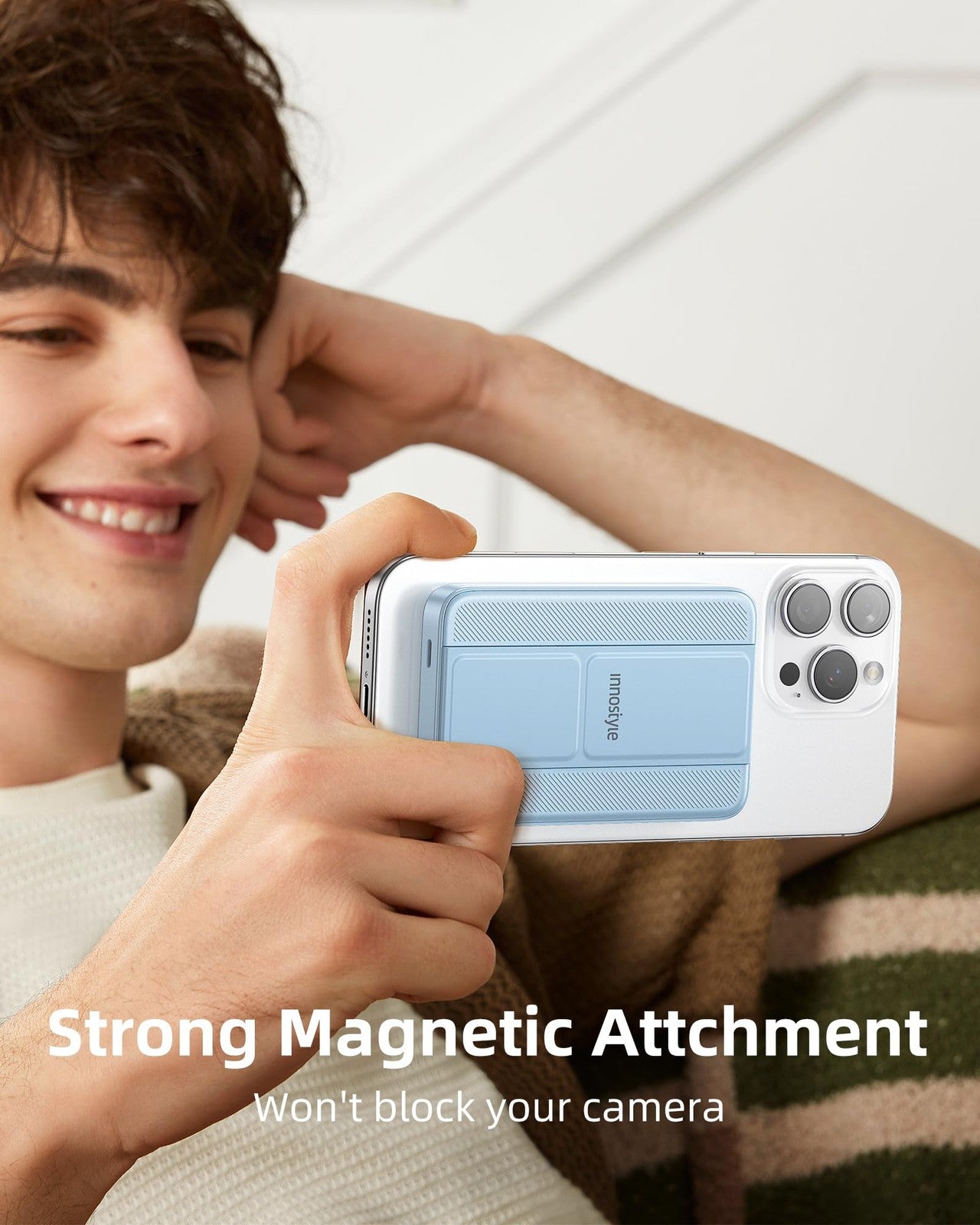 Innostyle 10000mAh magnetic portable wireless charger with foldable stand and USB charging port for smartphones.