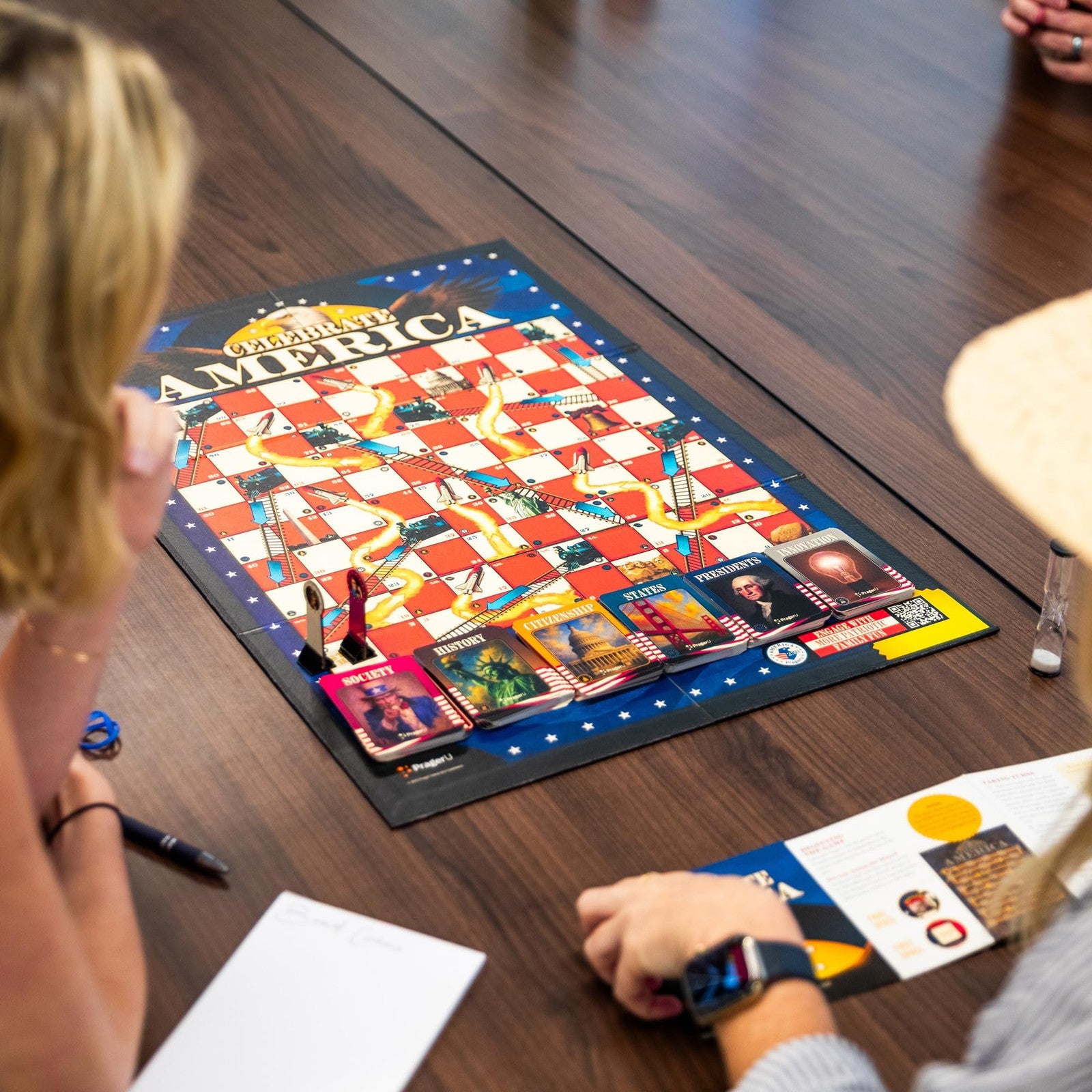 PragerU Celebrate America Race to The White House board game with colorful game pieces and a game board featuring USA-themed trivia.