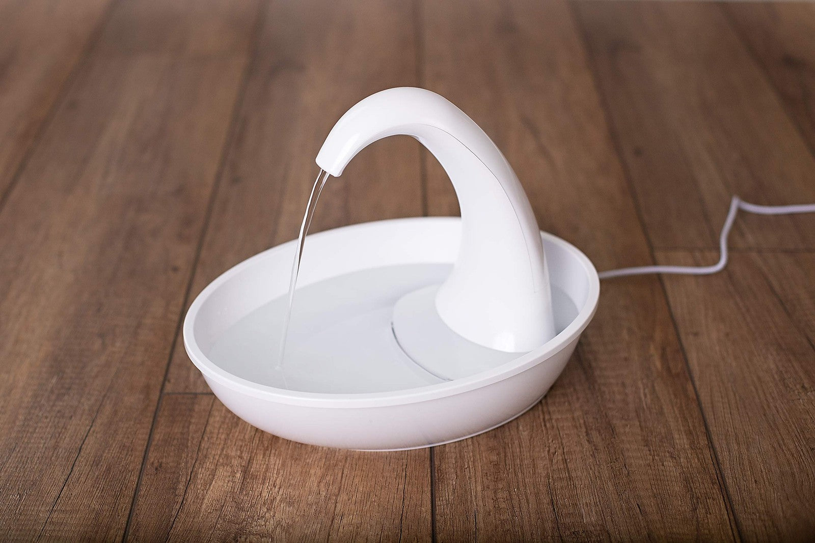 Pioneer Pet Swan pet drinking fountain for cats and dogs with 80oz capacity, featuring a sleek, modern design and flowing water.