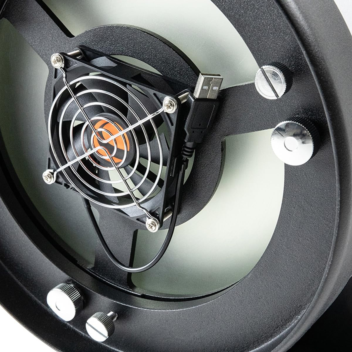 Celestron USB cooling fan attached to a Dobsonian telescope, helping to reduce temperature and improve image clarity during observations.