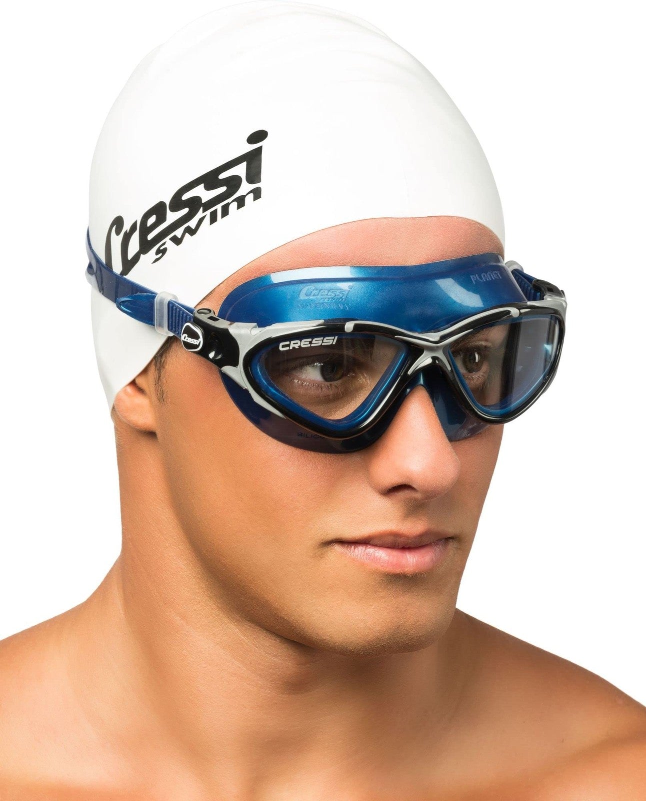 Cressi Planet swim goggles with clear, black, and silver smoked lenses, featuring a comfortable seal and adjustable strap for swimming.