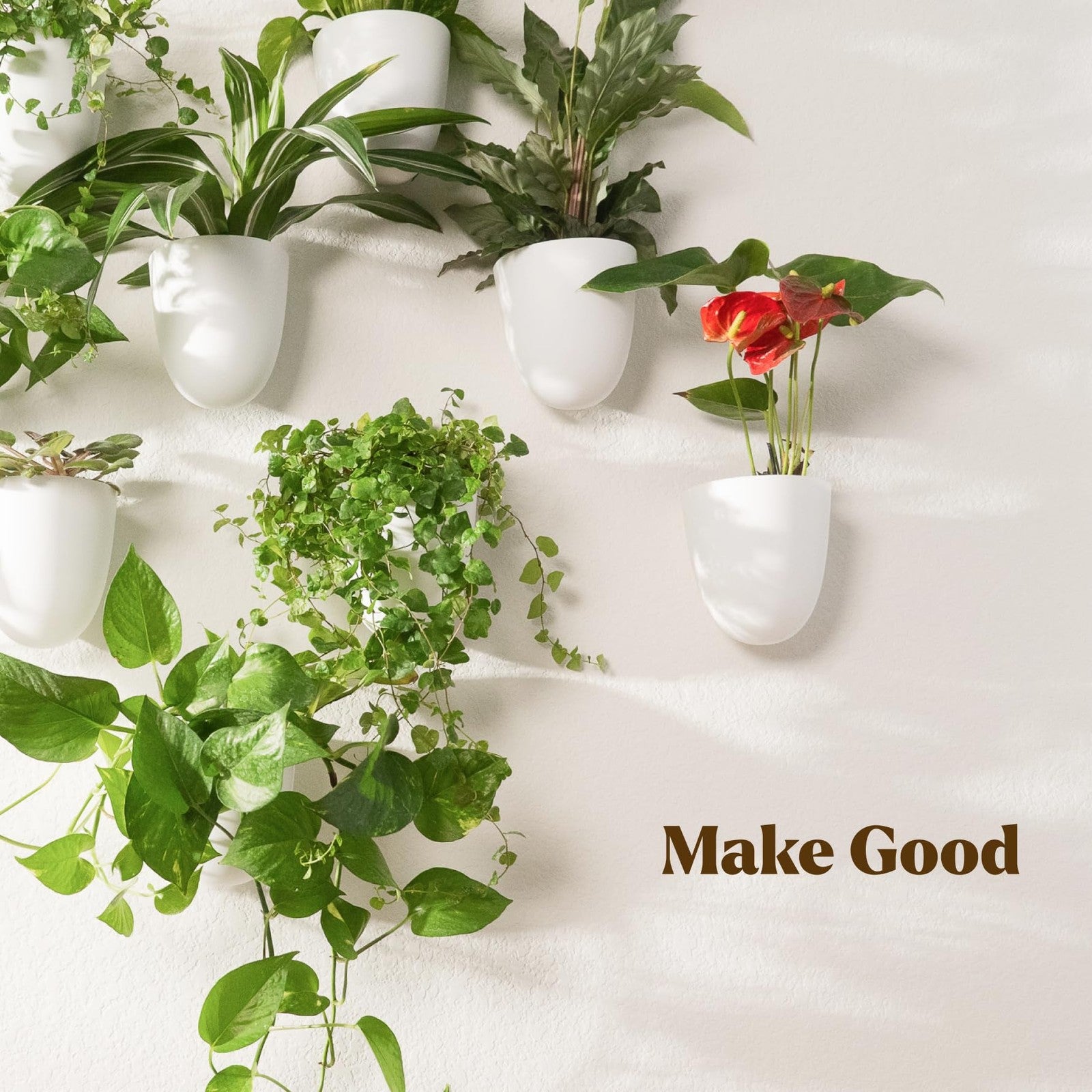 Make Good PlantPod Classic self-watering wall planter with six white indoor plant pots arranged vertically on the wall.