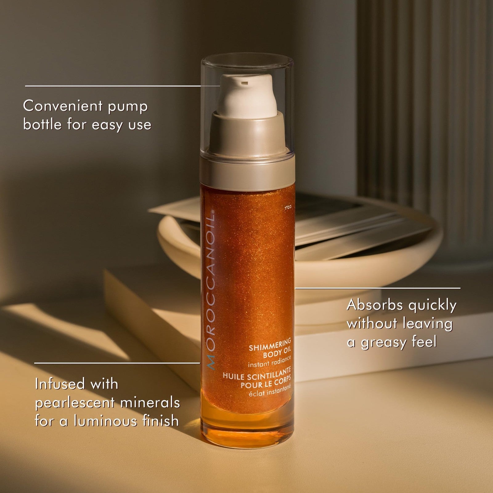 Moroccanoil Shimmering Body Oil in 1.7 fl oz bottle, featuring a sleek container with shimmering body oil inside.