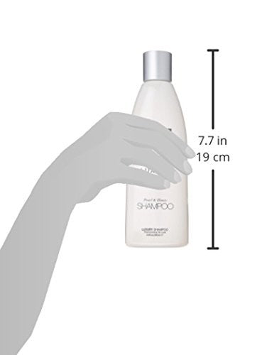 Bottle of UNITE Hair U:LUXURY Hydrating Shampoo with label visible, designed to strengthen and repair hair.