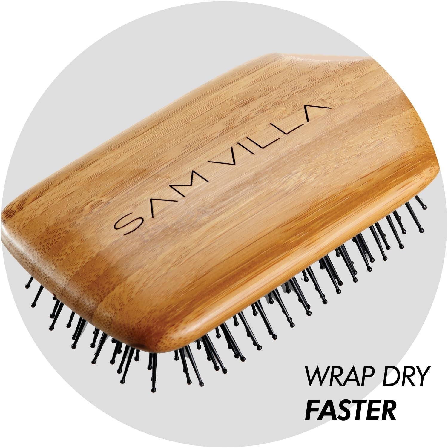 Sam Villa Signature Series bamboo paddle brush for hair styling, featuring a wooden handle and wide teeth for smooth, gentle detangling.