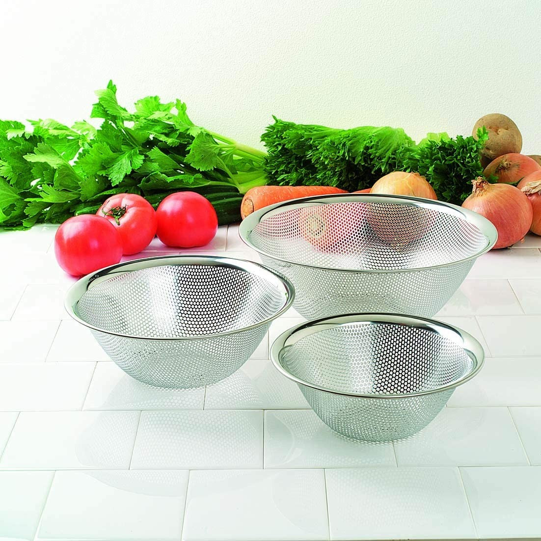 Stainless steel Sori Yanagi punching strainer with 10.6-inch diameter for drainage and clog prevention in kitchen sinks.