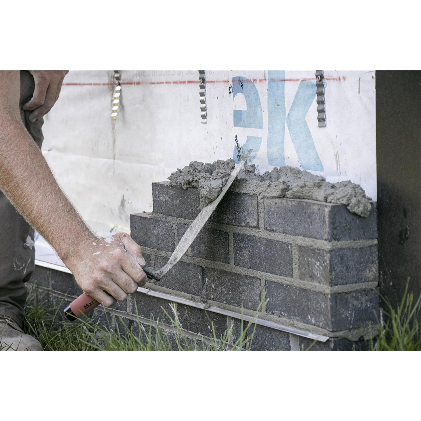 Marshalltown Philadelphia style brick trowel with a wooden handle, 10 x 5 inch masonry tool for bricklaying and pointing.