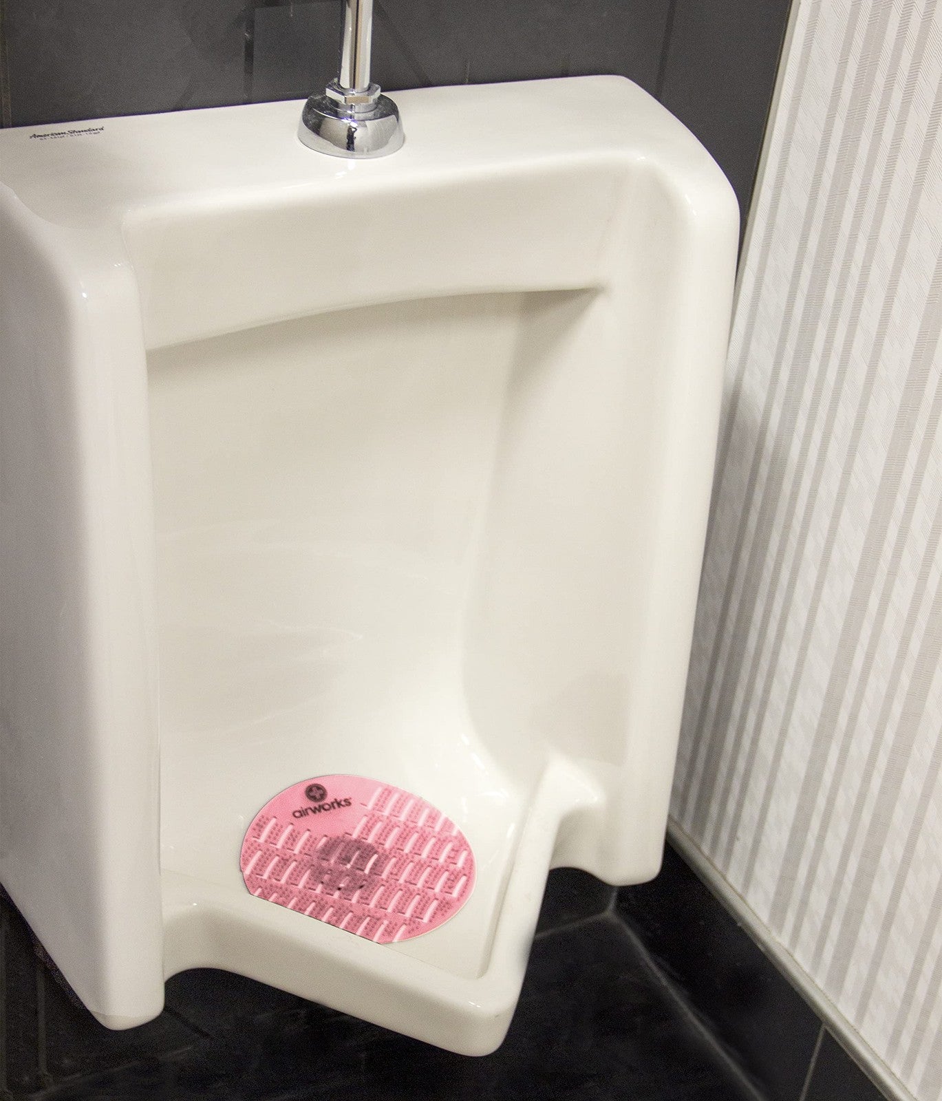 Set of 10 Hospeco Airworks Awus004-Bx urinal deodorizer screens in strawberry red for freshening and odor control.