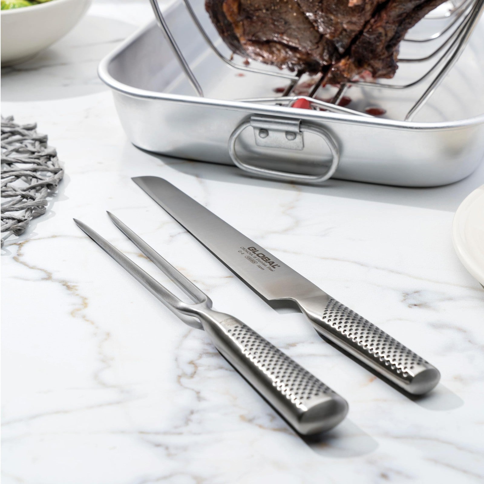 Global 7-inch forged stainless steel carving fork with lightweight Japanese design, featuring two sharp tines for precise meat handling.