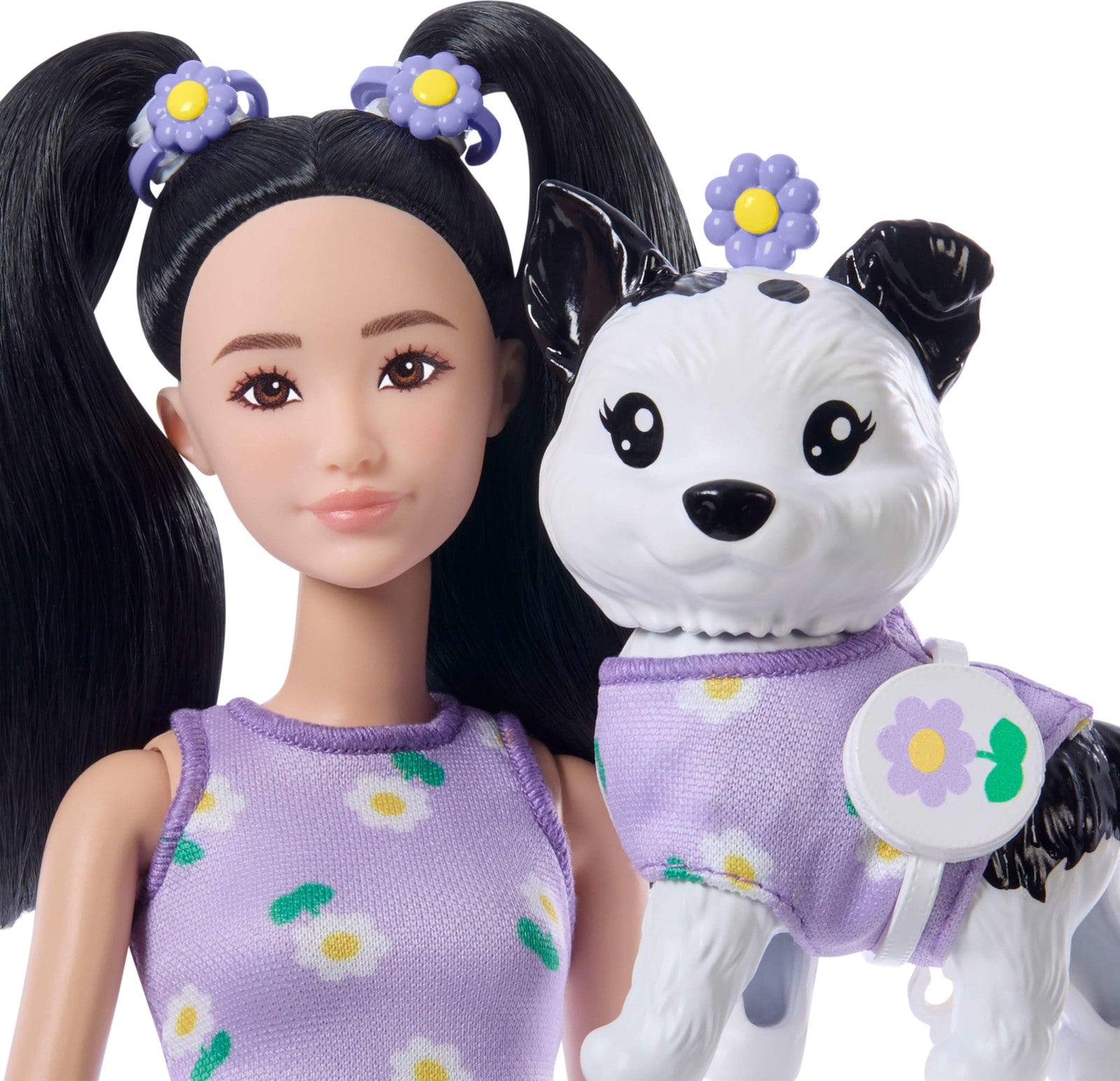 Barbie Twinning Looks doll and pet dog in matching purple daisy outfits, showcasing coordinated fashion for kids.