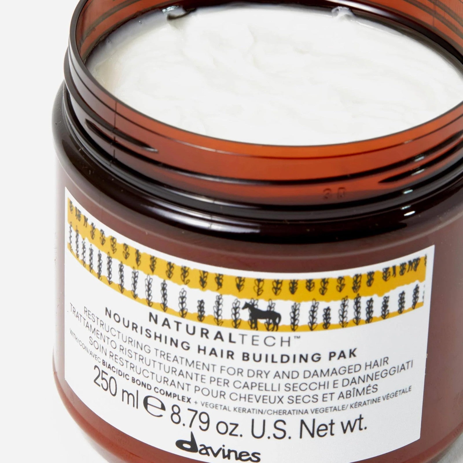 Davines Naturaltech Nourishing Hair Building Pack applied to hair shaft, reconditioning and strengthening hair for improved resilience.