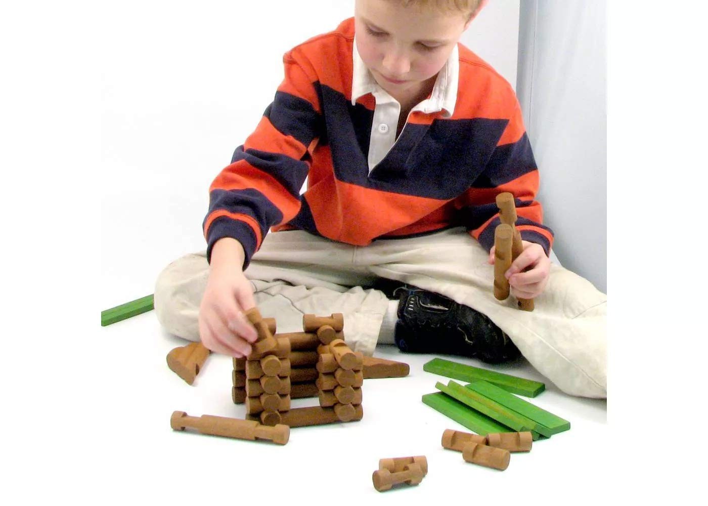 Maxim Enterprise Tumble Tree Timbers wood building set with 450 pieces, including logs for creative log construction projects.