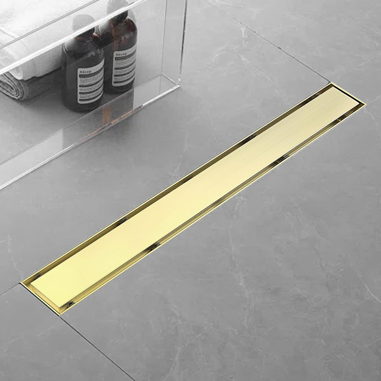 Eblog 24-inch linear shower drain made of AISI 304 stainless steel with a removable golden floor drain cover, suitable for modern bathrooms.