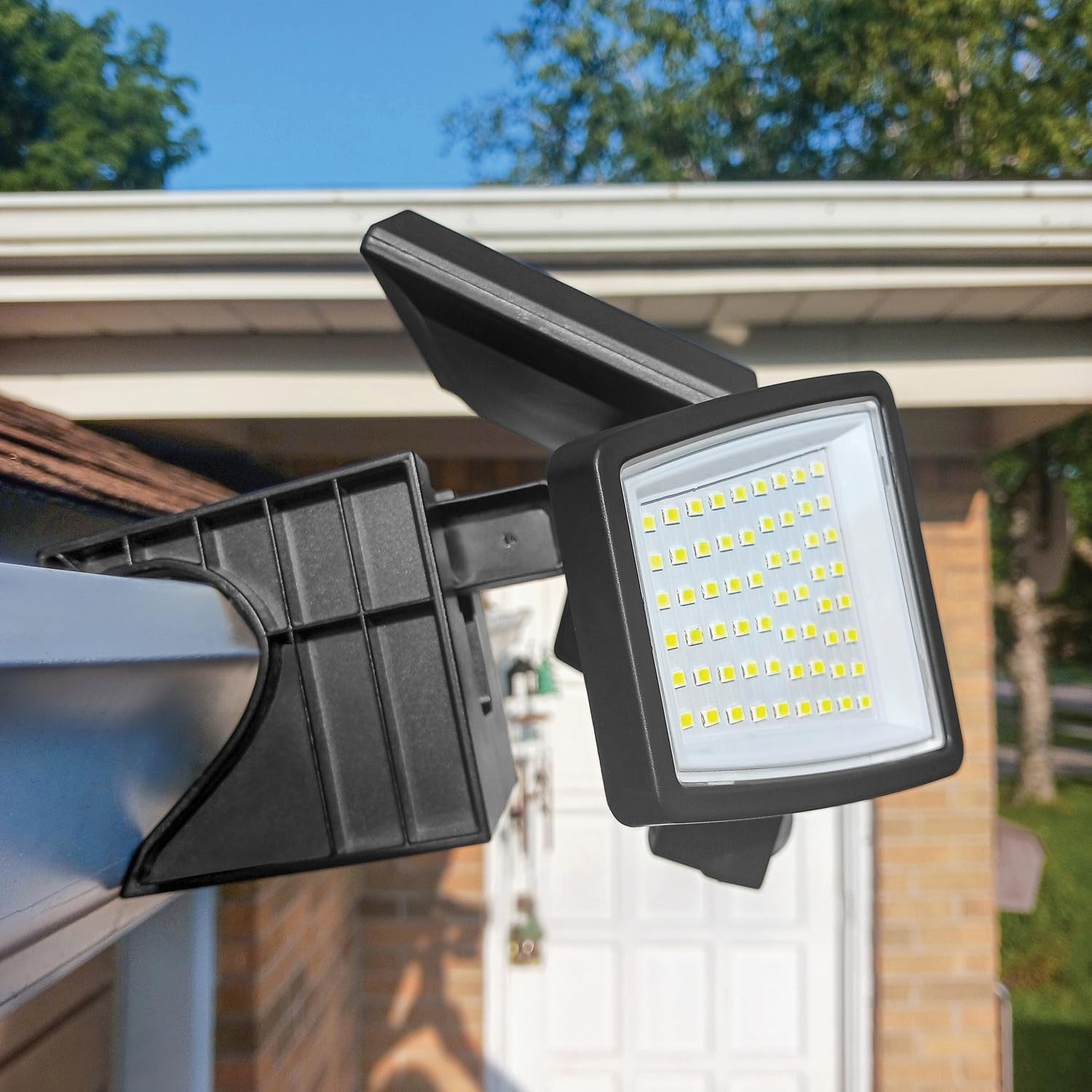 Toolless AMS1971 1000-lumen gutter-mount triple-head solar security light installed on a home gutter system.