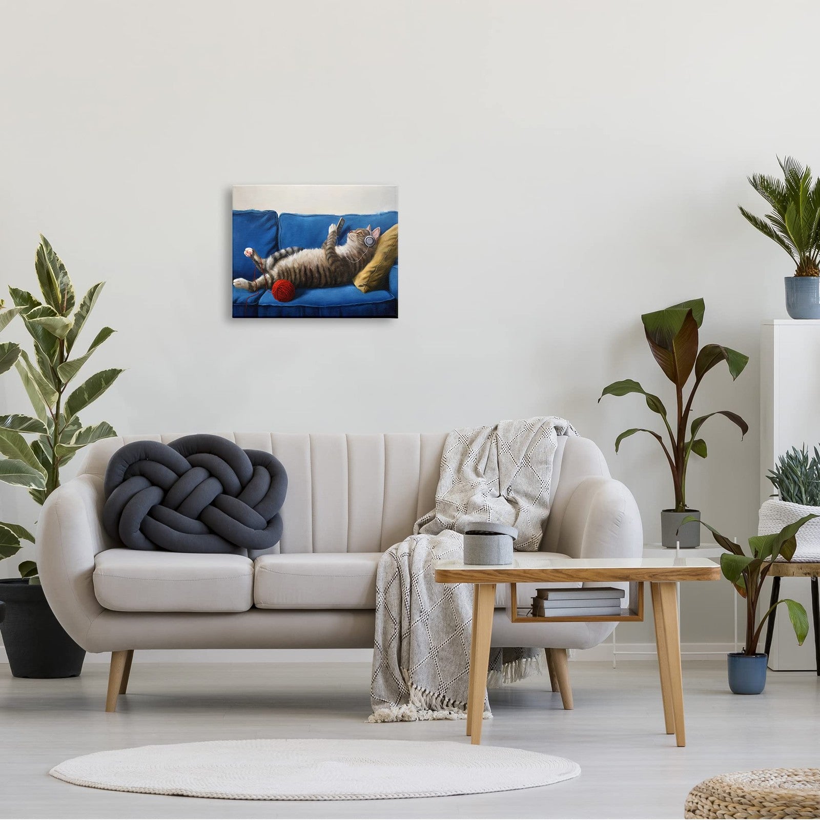 Stupell Industries cat couch relaxing with red yarn ball pet portrait by Luci, featuring a cozy feline lounging scene.