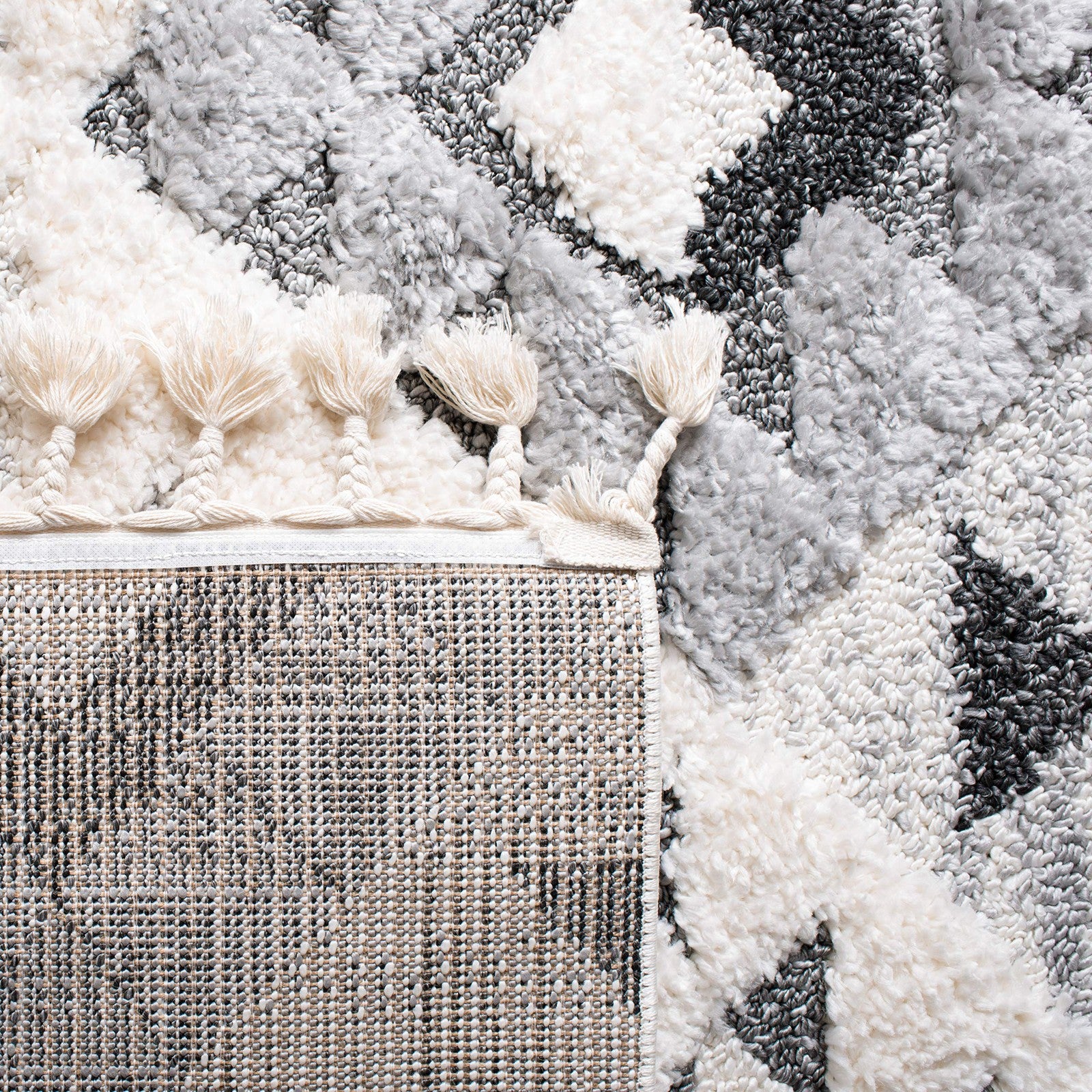 Safavieh Moroccan Tassel Shag Area Rug in round shape with ivory and grey boho design, featuring tassel accents on the edges.